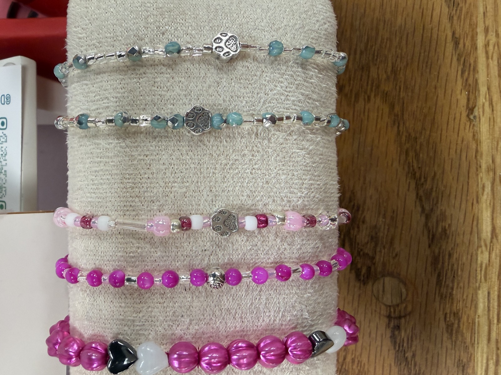 Kids' bracelets in pinks and blues with paw beads