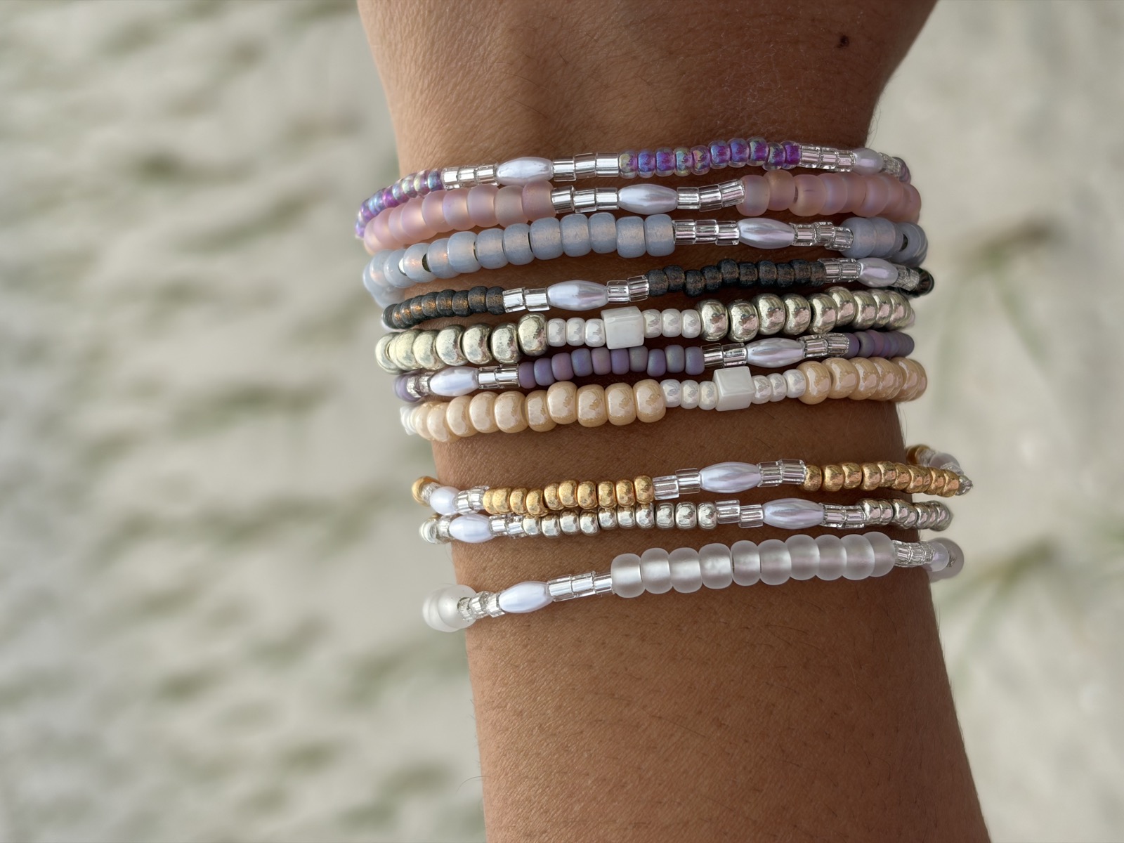 Wrist stack of bracelets on the sand