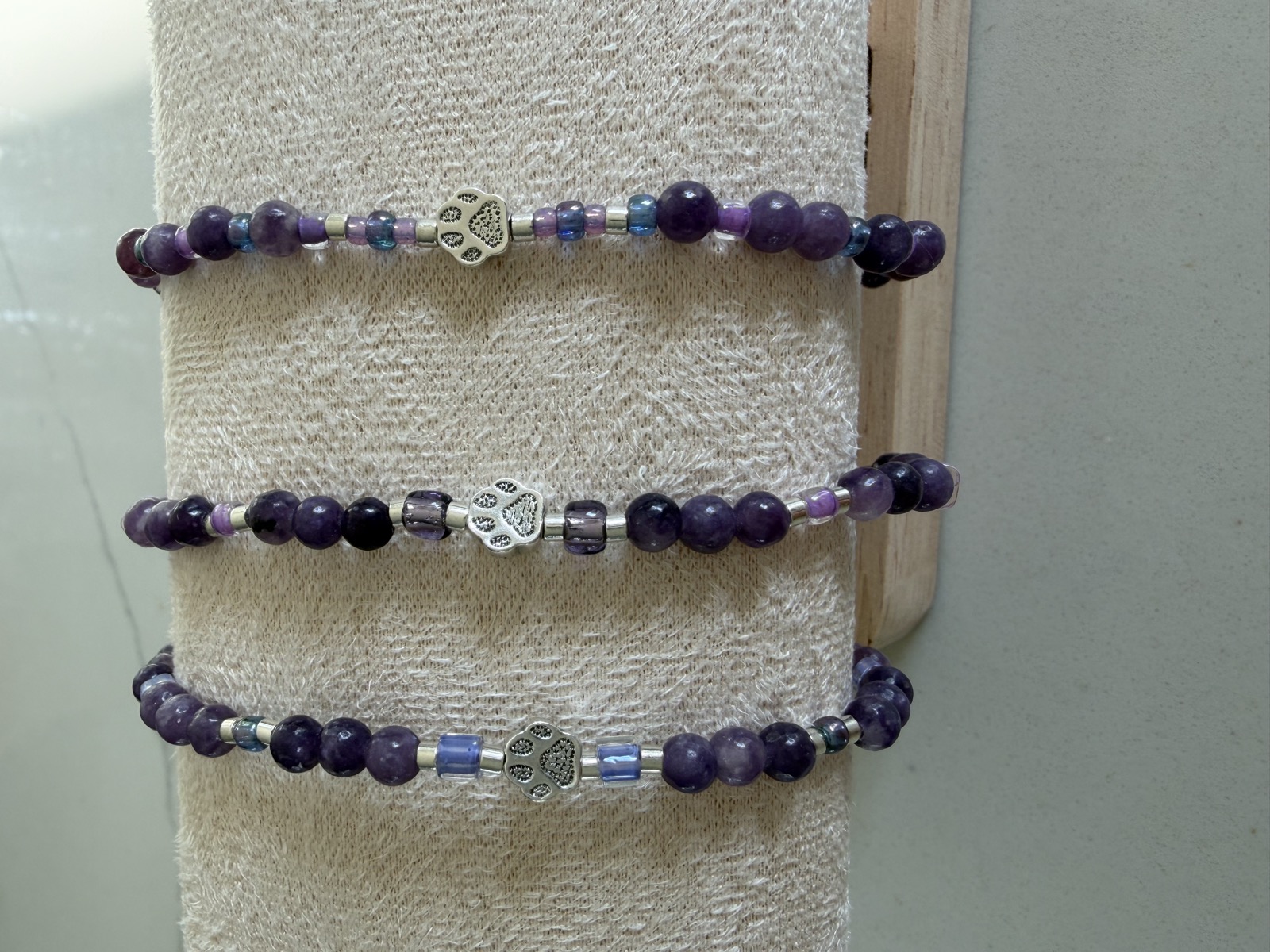 Three amethyst bracelets with paw print beads